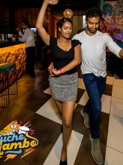 A couple executes a smooth turn. Every dance is a conversation, and our socials are where these beautiful dialogues happen all night long.