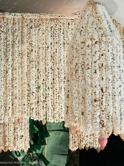 An enchanting chandelier made entirely of fragrant jasmine (mogra) and delicate pink lotuses. This was a stunning centerpiece for a traditional half-saree function, filling the air with a beautiful scent.