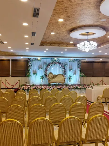 A view from the back of the hall, showing the guest seating and the stage.