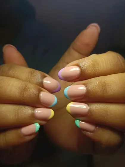 Summer French nails loving. This design features soft pastel tips on short, natural nails for a clean and cute look.