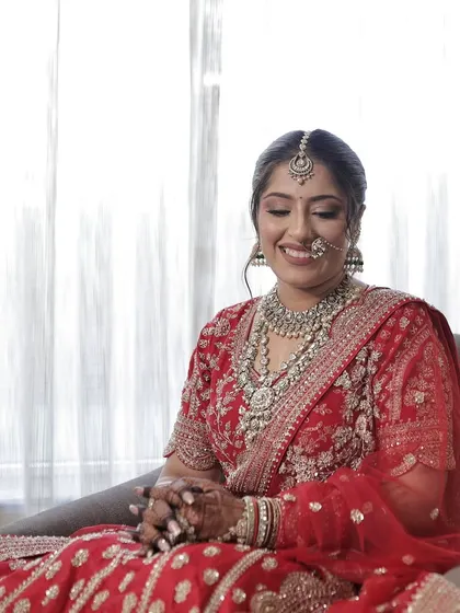 A happy bride smiling, showing how the makeup looks natural and radiant even in a candid moment.