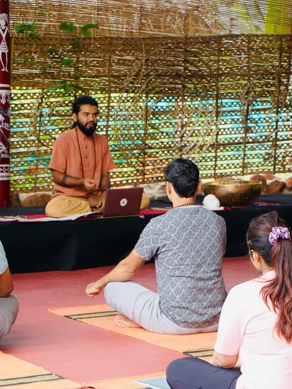 A student sits in meditation, surrounded by the tools of our practice. The course is a journey of self-discovery, guided by sound.