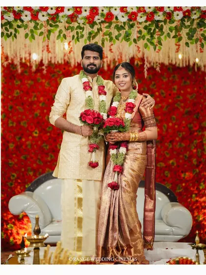 A classic stage portrait of the bride and groom in their beautiful wedding attire.