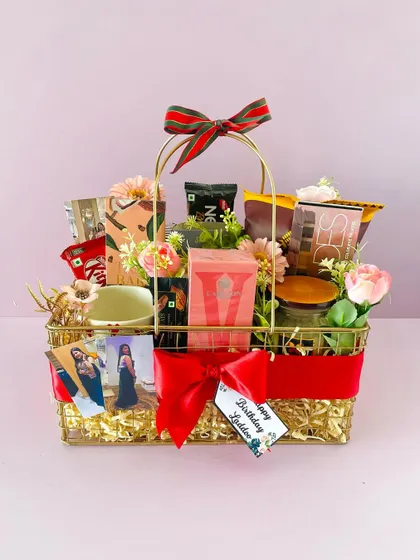 This bespoke gold metallic hamper was tailored for a birthday, featuring personal photos, snacks, and coffee, creating a truly unique and personal gift.