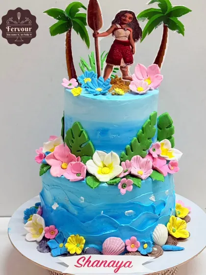 A vibrant two-tier Moana-themed cake, perfect for a tropical birthday party. The cake is decorated with ocean waves, tropical flowers, and a Moana topper, bringing the beloved movie to life.