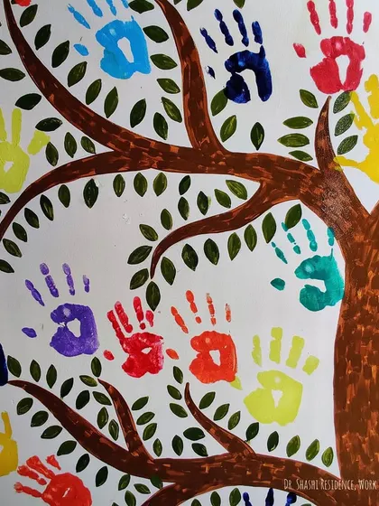 A close-up of the colorful handprints that form the leaves of the tree. Each print is a unique mark from the children who live here, making this mural a family treasure.