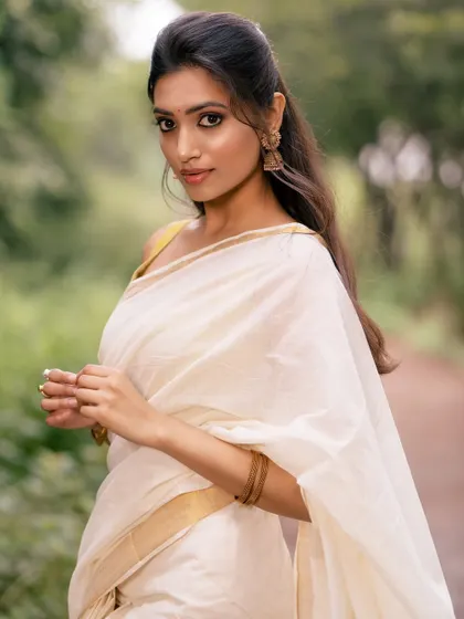 A profile shot of the model, highlighting her features and the elegant simplicity of her attire.