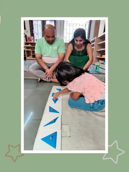 With intense concentration, Shrishti arranges constructive triangles. This activity challenges her spatial reasoning skills and ability to see patterns, all while her parents proudly look on.