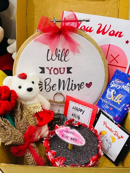 A close-up of the "Will You Be Mine" proposal hamper. It's a sweet and creative way to pop the question or celebrate your love, complete with a teddy, rose, and chocolates.