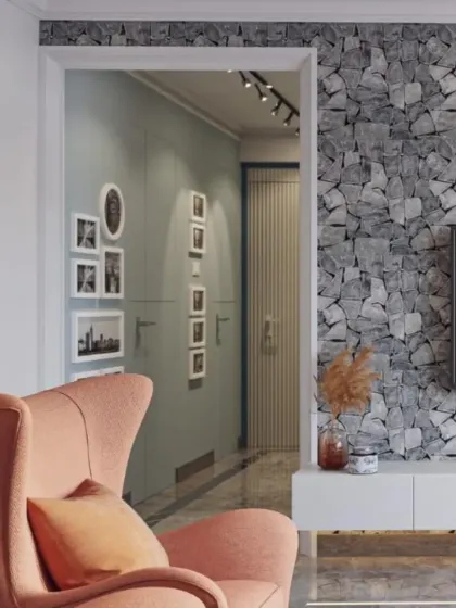 A peek from the living area into the hallway, showing how we maintain a consistent design language throughout the home. The stone texture wall and pastel armchair create a welcoming and stylish vignette.