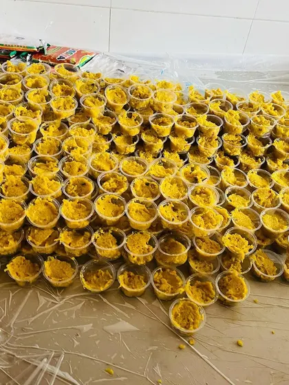 A large batch of our yellow sweet dish, portioned into individual cups. We can handle dessert orders for very large gatherings without any issue.