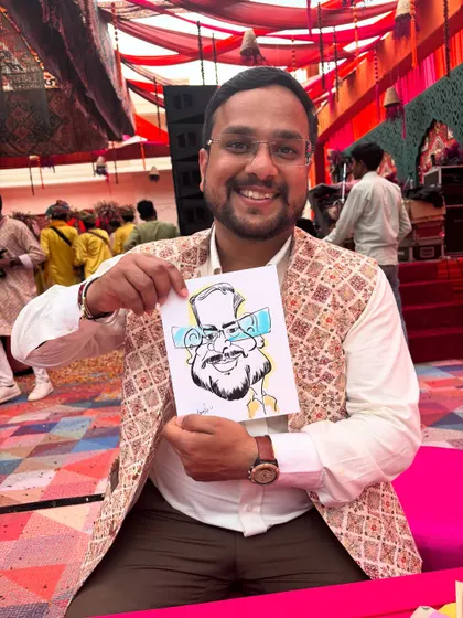 This gentleman looks so happy with his exaggerated portrait. It's a fun, personal memento from a special day.