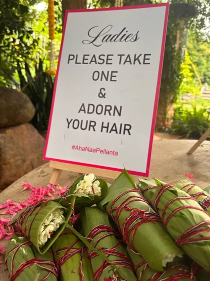 A thoughtful detail for guests: fresh jasmine strings wrapped in banana leaves, for ladies to adorn their hair.