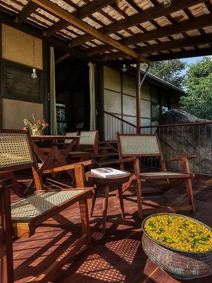 Relaxing on the wooden deck of the earthen studio. This space is all about slow living and embracing the tranquility of the natural environment.