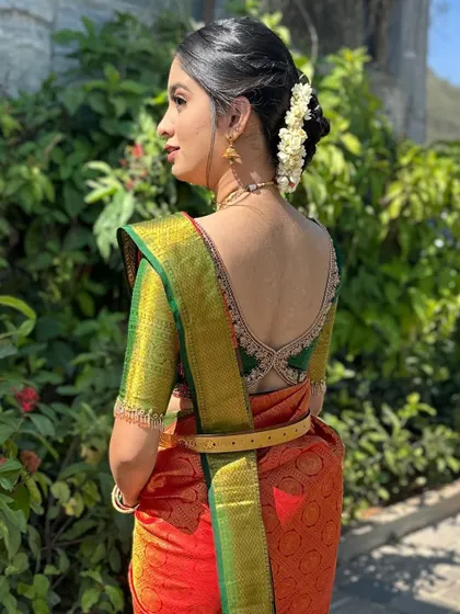 The client looking elegant, her hairstyle perfectly showing off the beautiful back design of her custom blouse.