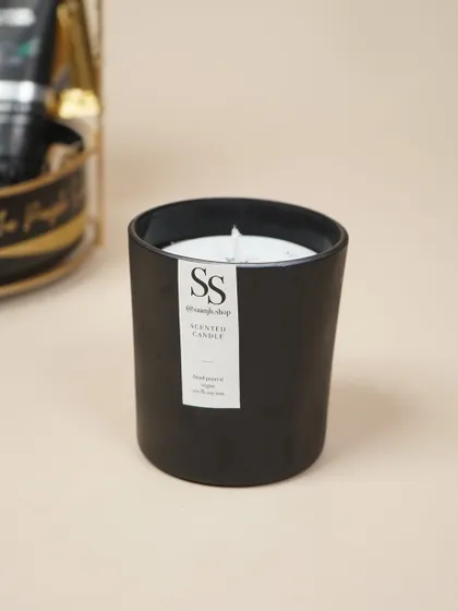 A masculine, scented candle from Saanjh Shop adds a touch of ambiance to the men's birthday hamper.