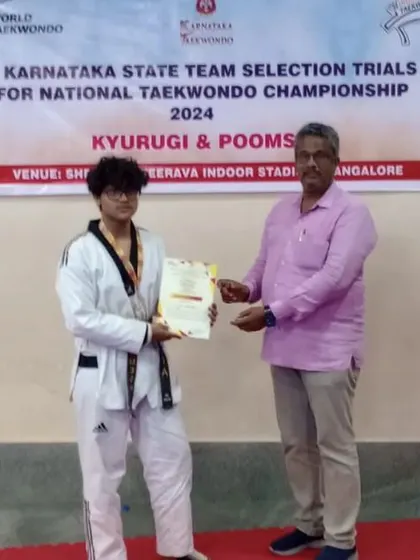 A student receiving his certificate after being selected for the Karnataka State Team.