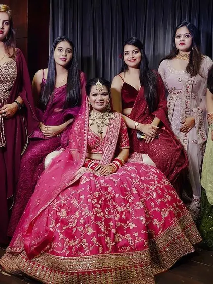 A beautiful, posed portrait of the bride with her bridesmaids. Everyone looks elegant and happy, creating a timeless photo of the bride and her closest friends.