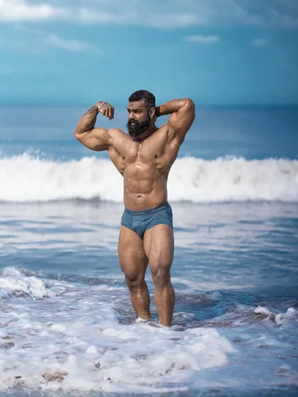 A powerful pose in the ocean, showcasing my current condition. This is what happens when you commit to the process and never give up on your goal.