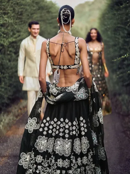 An intricate pearl-draped bun created for a campaign with designer Abhinav Mishra. This style combines classic elegance with detailed accessory work for a high-fashion ethnic look.