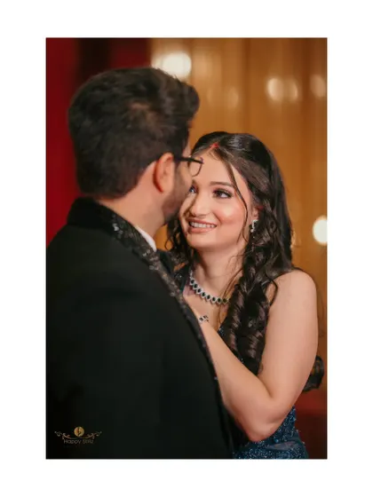 A sweet, over-the-shoulder shot of the bride looking back at her groom during their ring ceremony. Her happy expression captures the love and excitement of the moment.