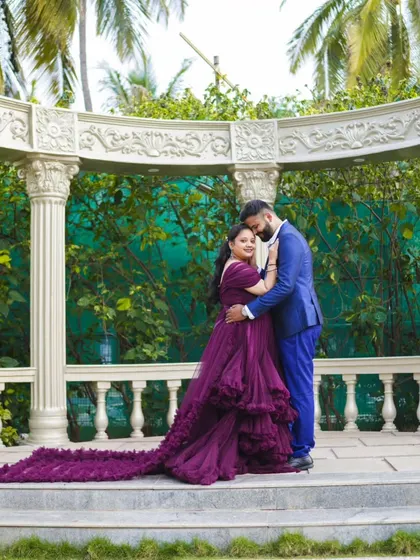 A grand and romantic pose in a garden gazebo. The long train of the purple gown adds a touch of royalty to this pre-wedding photo.
