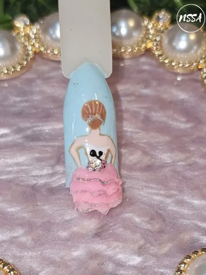 A 3D ballerina design, complete with a fluffy tulle skirt. This piece combines sculpting and texture to create a whimsical and elegant character on the nail.