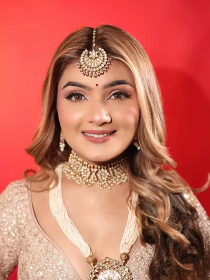 An ethereal day bride look, featuring soft brown eyeshadow, winged liner, and a matte nude lip. The skin is kept fresh and glowing for a natural, sun-kissed finish.
