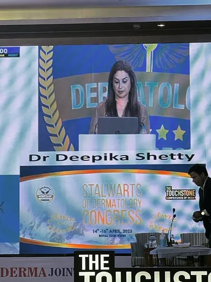 My presentation on the main screen at the dermatology congress. It's a humbling experience to share my work on such a prominent platform.