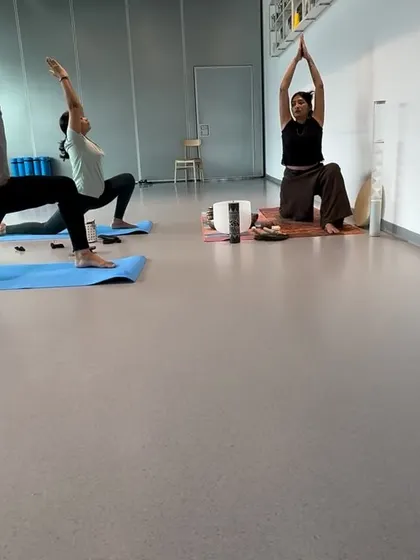 Guiding participants into a low lunge at a corporate session. This is a fantastic hip opener to counteract the effects of sitting for long hours.