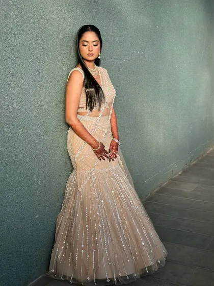 A full-length portrait of this bride in her stunning beige lehenga, looking graceful and elegant.
