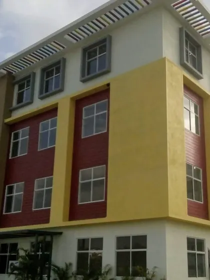 A corner view of the Asia Pacific World School building, demonstrating how the colorful design wraps around the structure.