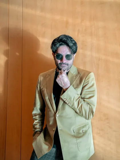 A touch of old-school cool. The sunglasses add a bit of mystery and charm to this already dapper look.