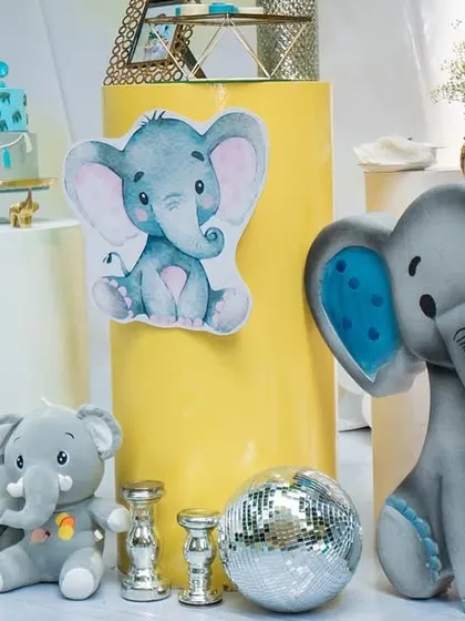 More cute details from the baby elephant party. The combination of a large elephant prop, a sequin backdrop, and themed desserts created a visually rich and adorable setup.