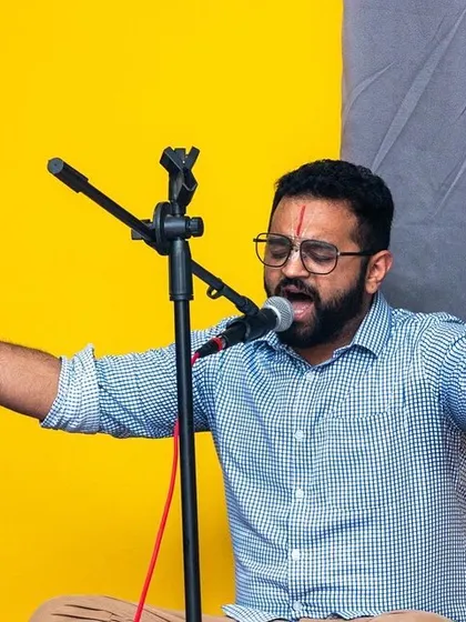 The lead singer during our Bhakti Immersion Kirtan event, passionately leading the group in devotional chants. These events allow our community to explore the path of Bhakti Yoga through music and song.