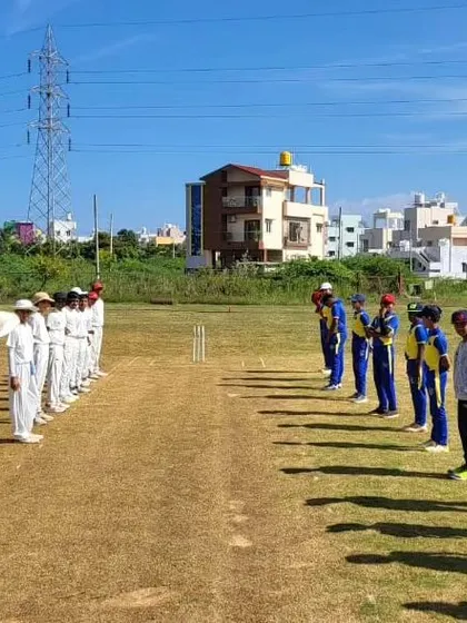 Both teams lined up on the pitch, showing respect before the start of the game in Hubli.