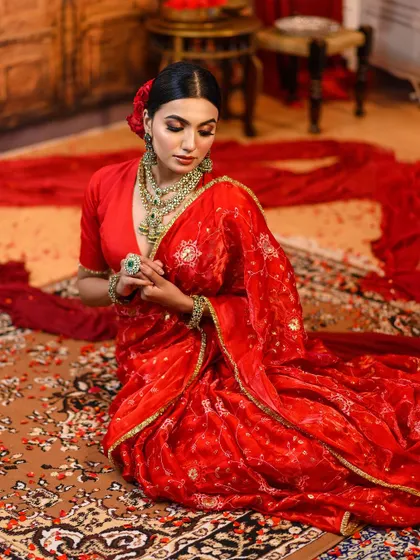The complete look, showcasing the flow of the saree and the elegance of the makeup and hair.