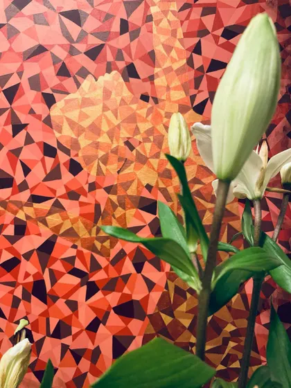 "SHE DANCES." This painting of a ballet dancer, set against a fiery, geometric background, is a celebration of the joy of being a woman. It captures her focus and grace as she spins in a quiet moment made of mirrors and light.