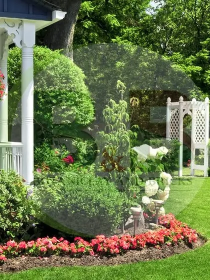 A classic English-style garden design. This front yard features abundant flowerbeds with colorful blooms, neatly trimmed hedges, and charming garden statues, creating a welcoming and picturesque entrance.