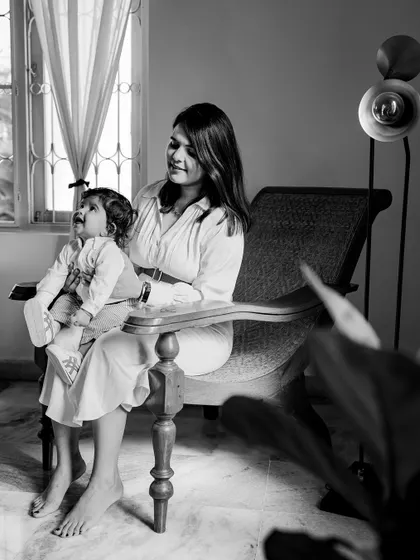 The same warm, sunlit portrait of a mother and child, rendered in beautiful black and white. This version emphasizes the light, shadows, and the peaceful expression on their faces.