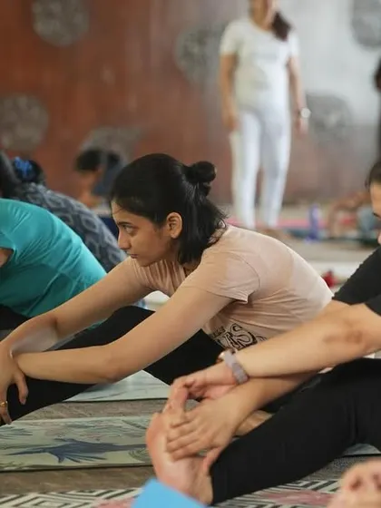 A deep forward fold during a community yoga event. It's beautiful to see so many practitioners breathing and stretching as one.