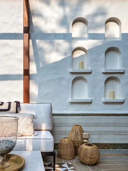 The terrace at Summer Haus features these beautiful arched niches, which create a play of light and shadow. This detail adds architectural interest and provides a perfect spot for displaying candles and decor.
