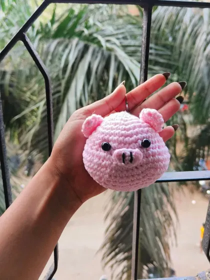 A close-up of my new crochet pig keychain. I focused on getting the round face and perky ears just right. It’s such a cheerful little accessory.