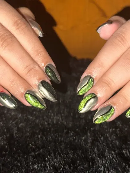An edgy and modern design combining a silver-grey metallic polish with a vibrant green cat-eye effect. The diagonal split in the design adds a graphic and dynamic element to the look.