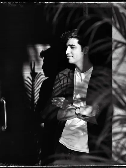 Anhad, with palm shadows creating a beautiful pattern of light on him. This 'Doorways' shot plays with reflections and natural elements.