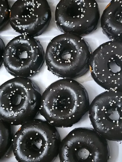 A close-up of our rich chocolate donuts, a popular item in our customized snack boxes for birthday parties.