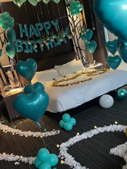 This angle shows the pathway of white petals and the arrangement of green and white balloons, creating a cohesive and stylish look.