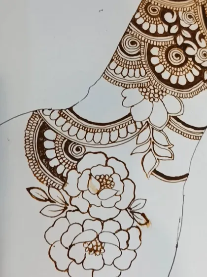 An in-progress shot of a floral design on a practice hand outline. This shows how we build up layers, starting with the main floral elements.