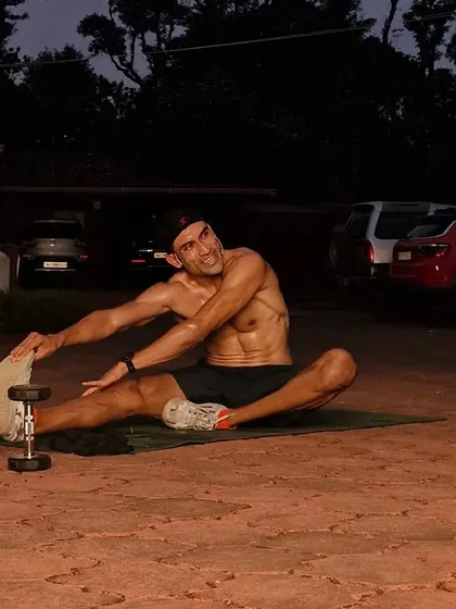 Effort equals joy. A good stretch after a tough workout is one of the best feelings. This is a shot from a late-night session, showing that the grind happens at all hours.