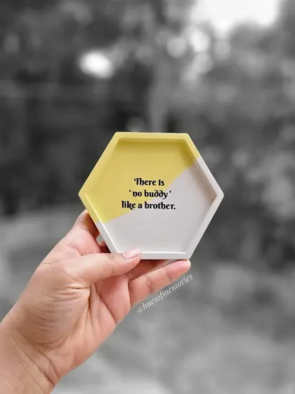 The yellow version of the 'no buddy like a brother' coaster. The bright color adds a cheerful touch to this thoughtful gift.